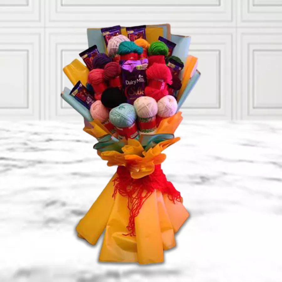 A colorful bouquet made of assorted knitting wools paired with Cadbury chocolates, including Dairy Milk Silk and Roast Almonds.