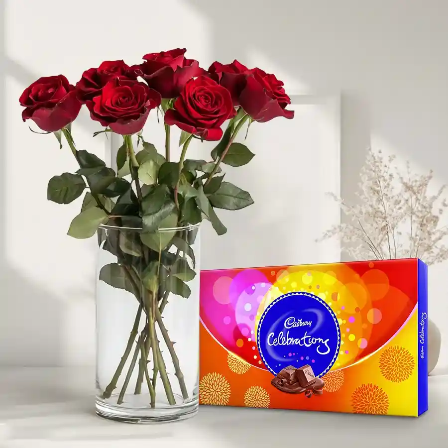 A charming gift combo featuring 6 red roses in a glass vase alongside a Cadbury Celebrations pack.