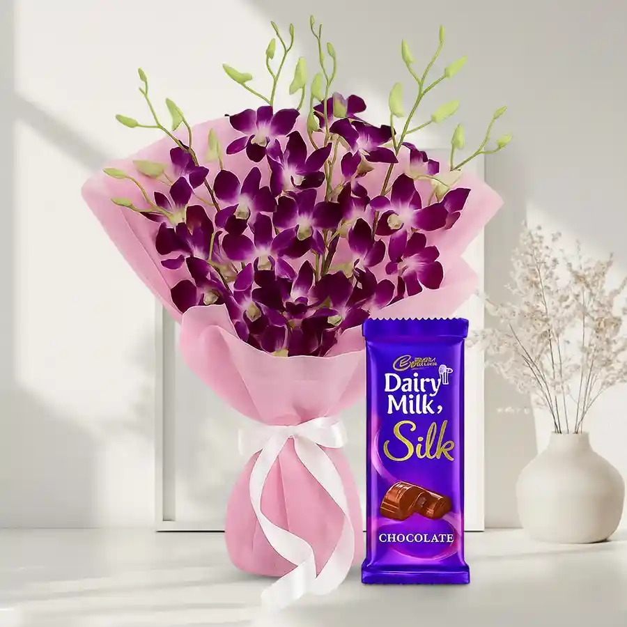 A bouquet of 6 vibrant orchids with a 70g Cadbury Dairy Milk Silk chocolate bar, ideal for gifting on special occasions.