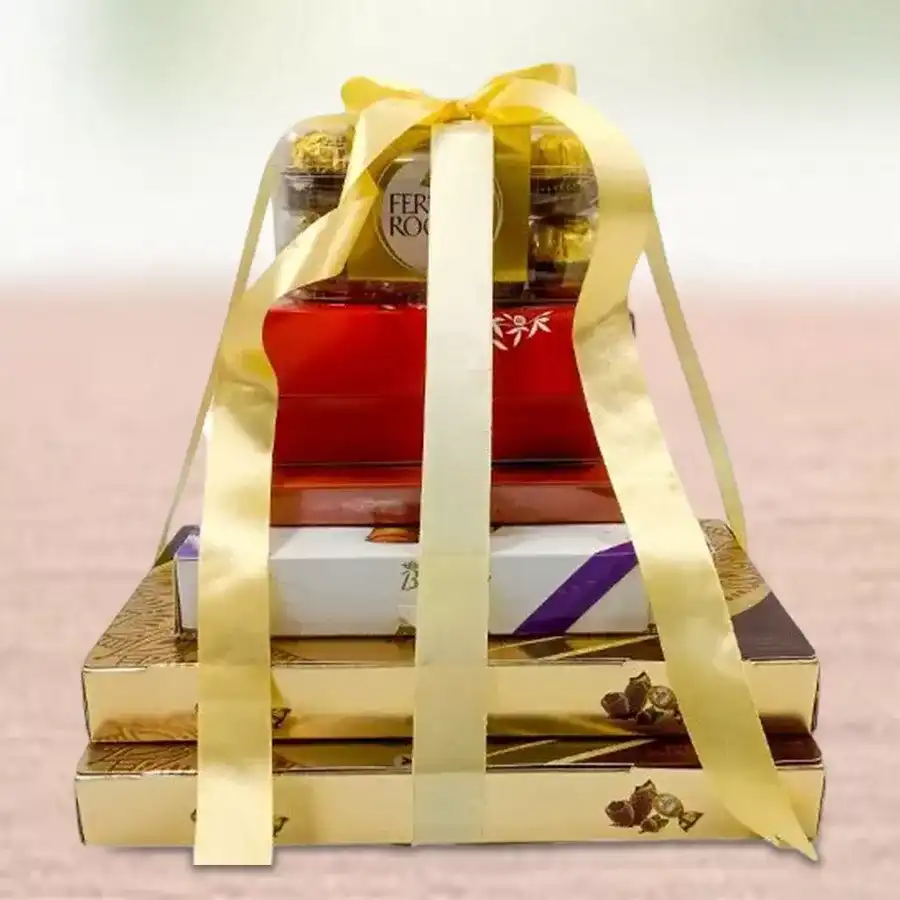 5 tier chocolate tower arrangement featuring Ferrero Rocher, Belgian chocolates, Lindt Swiss Thins, and Lindor pieces