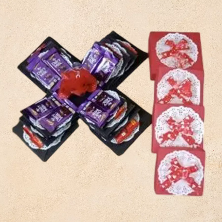Extravagant 4-layer explosion box filled with Nestle KitKats and Cadbury Dairy Milk bars, accompanied by a teddy keychain holder.