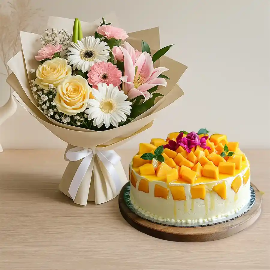 A vibrant bouquet of mixed flowers paired with a delicious mango cake, perfect for celebrating special moments.