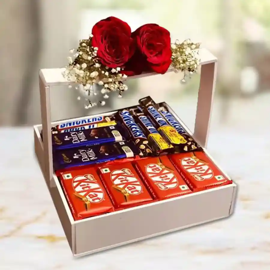 Stunning gift basket filled with assorted chocolates including KitKats, Cadbury Dairy Milk bars, and Snickers, presented in a wooden basket.