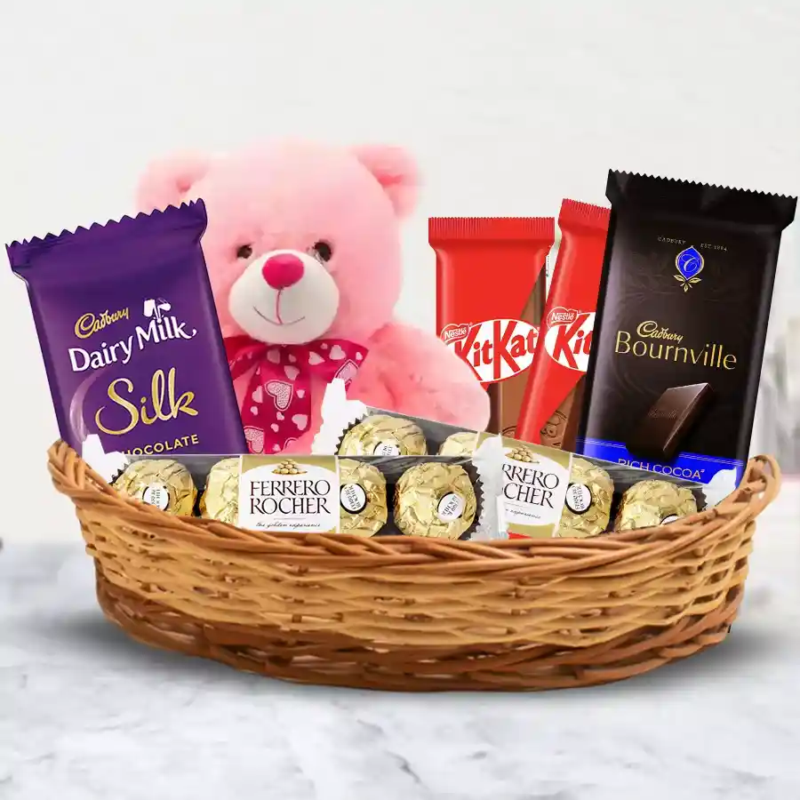 Gift basket featuring chocolates and a teddy bear, perfect for gifting.