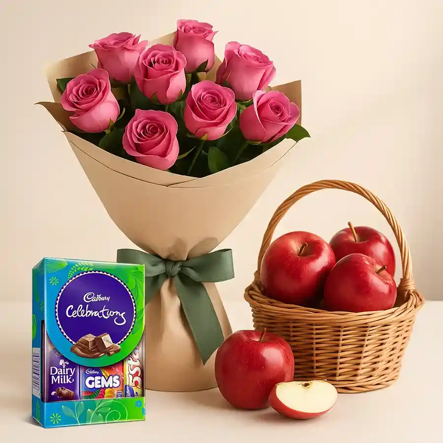 A vibrant gift set featuring 12 pink roses, a Cadbury Dairy Milk Celebration pack, and a basket of fresh apples, ideal for celebrations.