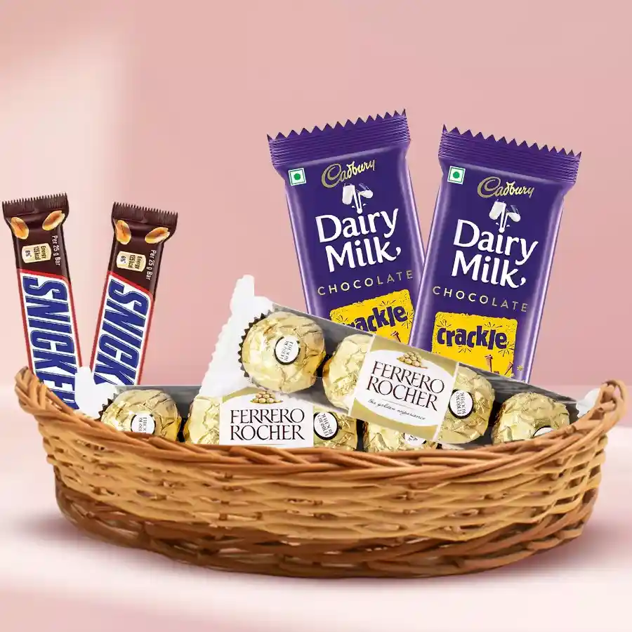 An enticing Divine Chocolate Delight Basket featuring Ferrero Rocher, Cadbury Dairy Milk Crackle, and Snickers, perfect for gifting or personal indulgence.