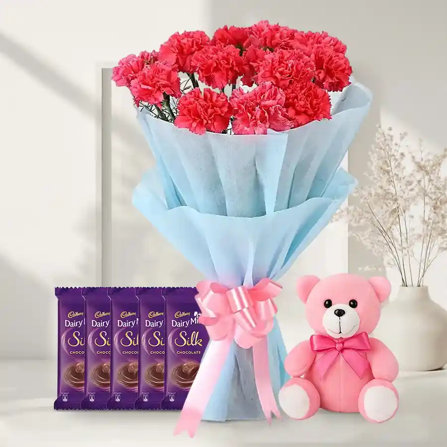 A charming gift set featuring pink carnations, Cadbury chocolates, and a teddy bear. Perfect for expressing love and affection.
