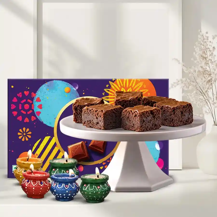 Festive Gift Hamper with brownies, Cadbury pack, and decorated diyas for Diwali celebration.