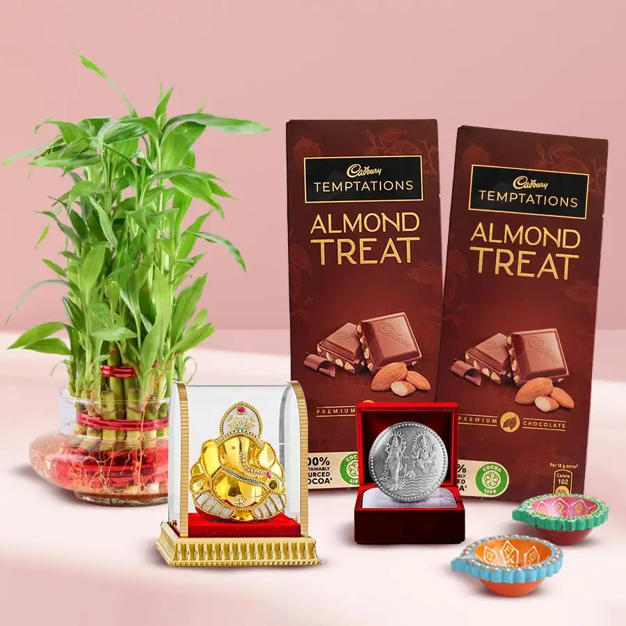 Elegant Bamboo Blessings Gift Set featuring a lucky bamboo plant, Ganesh murti, chocolates, mud diyas, and a silver-plated coin for Diwali.