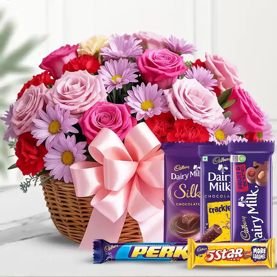A tall basket filled with vibrant exotic flowers and assorted big Cadburys chocolates.