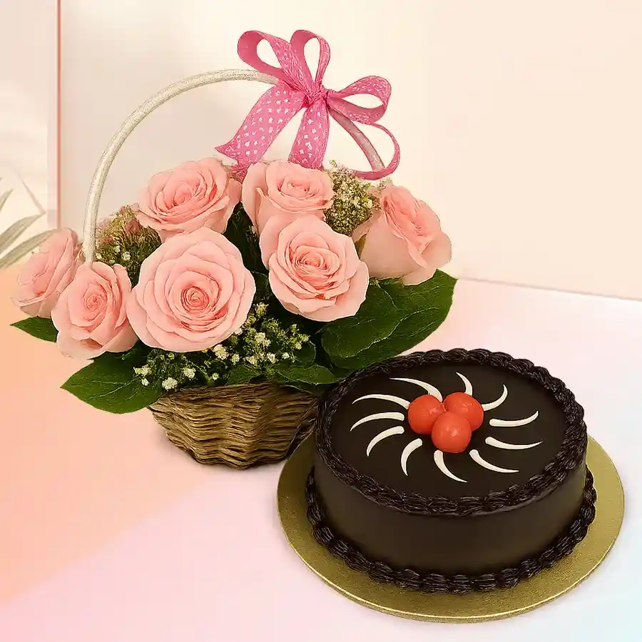 Basket of twelve pink roses paired with a round chocolate truffle cake. Perfect gift for Rose Day and special occasions.