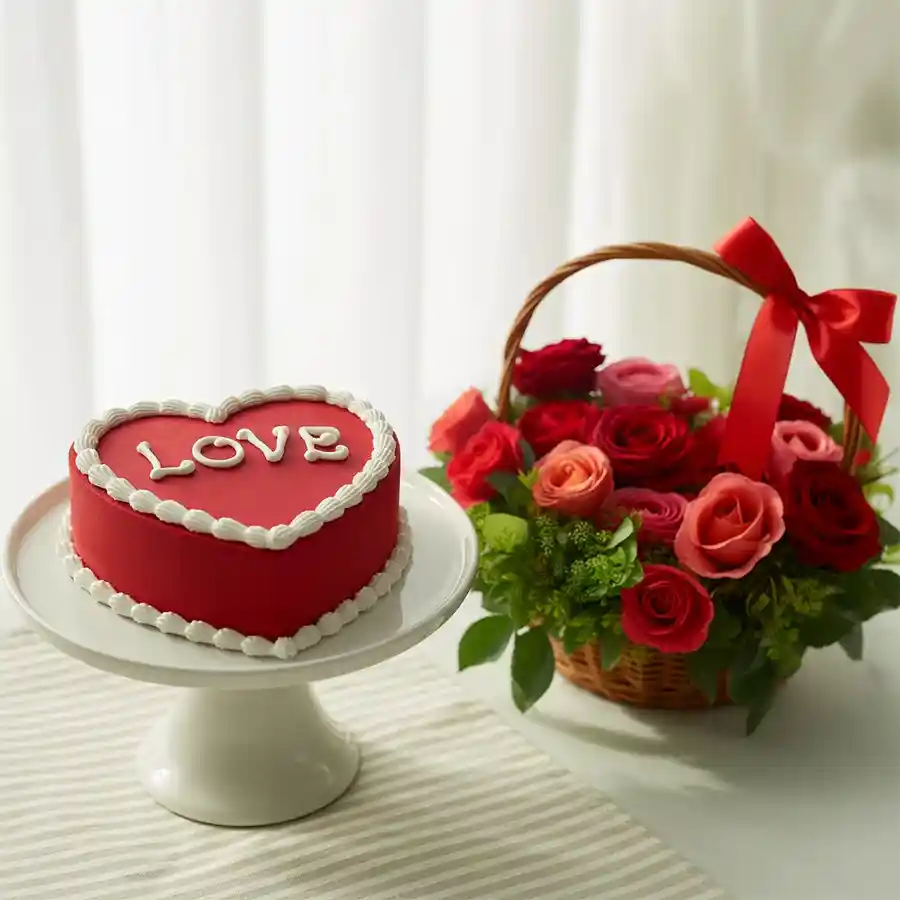 A basket of 12 assorted roses alongside a heart-shaped red velvet cake with "Love You" topping. Perfect for expressing love and joy.