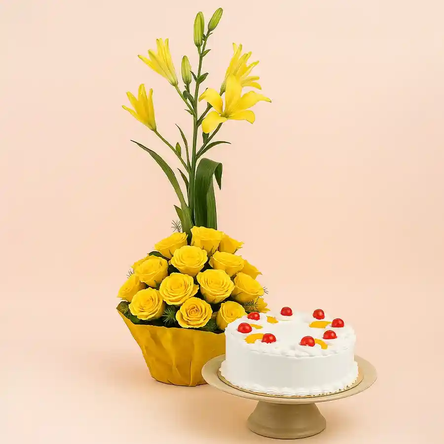 A delightful combo featuring a mixed fruit cake and a vibrant yellow flower basket with roses and lilies, perfect for celebrations.