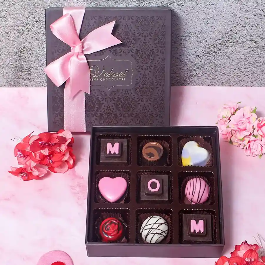 Delicious Mom Chocolates N Hearts Gift Box featuring nine assorted chocolates engraved with "Mom" in an elegant packaging.