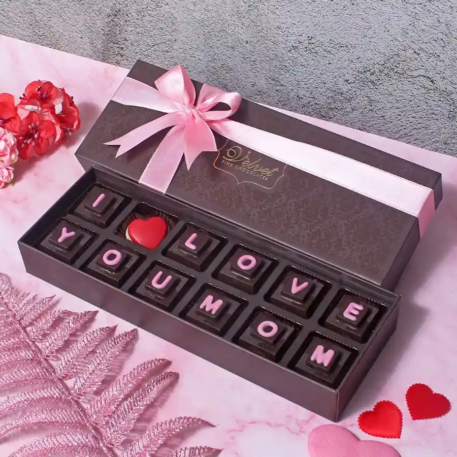 A beautifully packaged box of 12 engraved chocolates with "I Love You Mom" messages, perfect for Mother's Day gift.