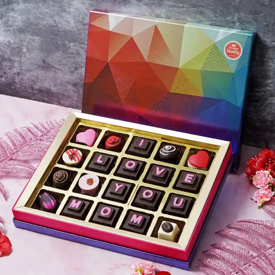 Assorted chocolates in a beautifully wrapped box with the message "I Love You Mom" for Mother's Day.