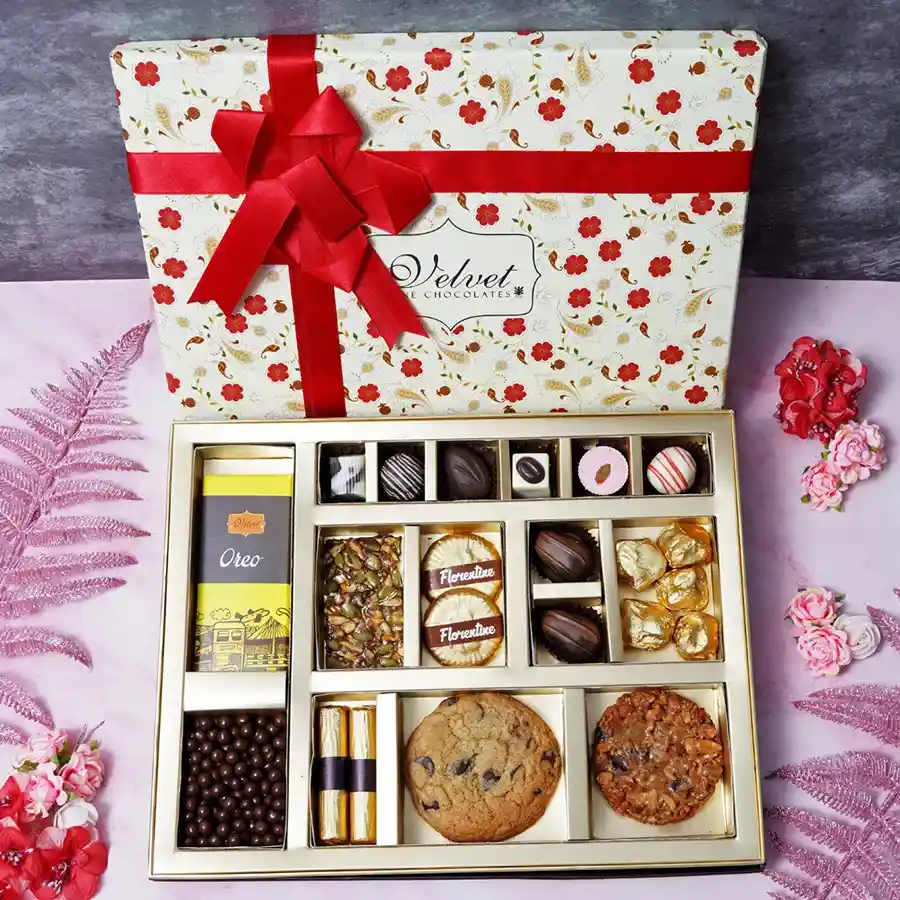 Deluxe Choco Selection Box featuring assorted chocolates, Oreo chocolate bar, almond florentines, almond rocks, butterscotch, assorted logs, and cookies.