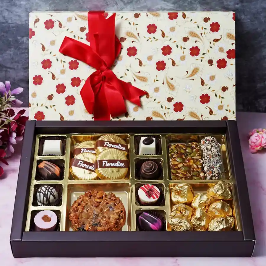 A beautifully arranged box of assorted chocolates, florentines, seed squares, almond fingers, and almond rocks for Mother's Day gift.