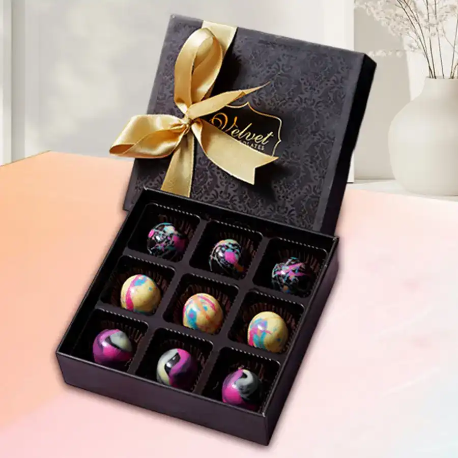 Special Mother's Day Chocolate Bonbons Box featuring nine beautifully crafted chocolates in a marble finish, including Salted Caramel Ganache, Passion Fruit, and Feuilletine Crunch pieces.