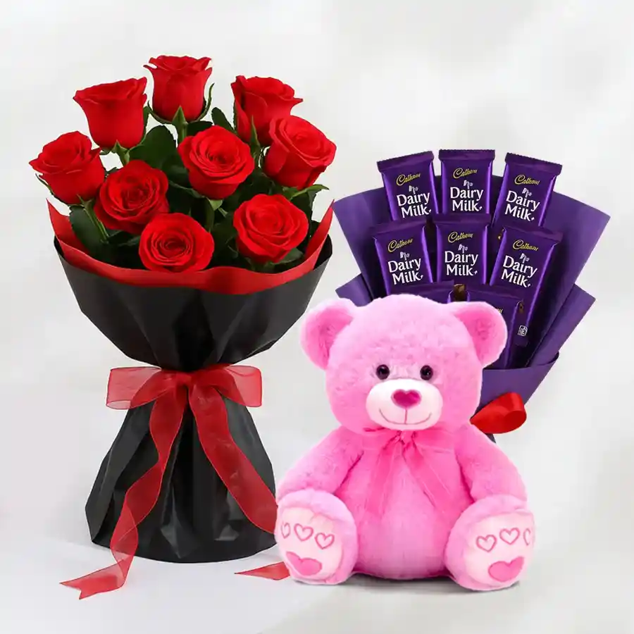 Heartfelt gift set featuring red roses, chocolates, and a teddy bear.