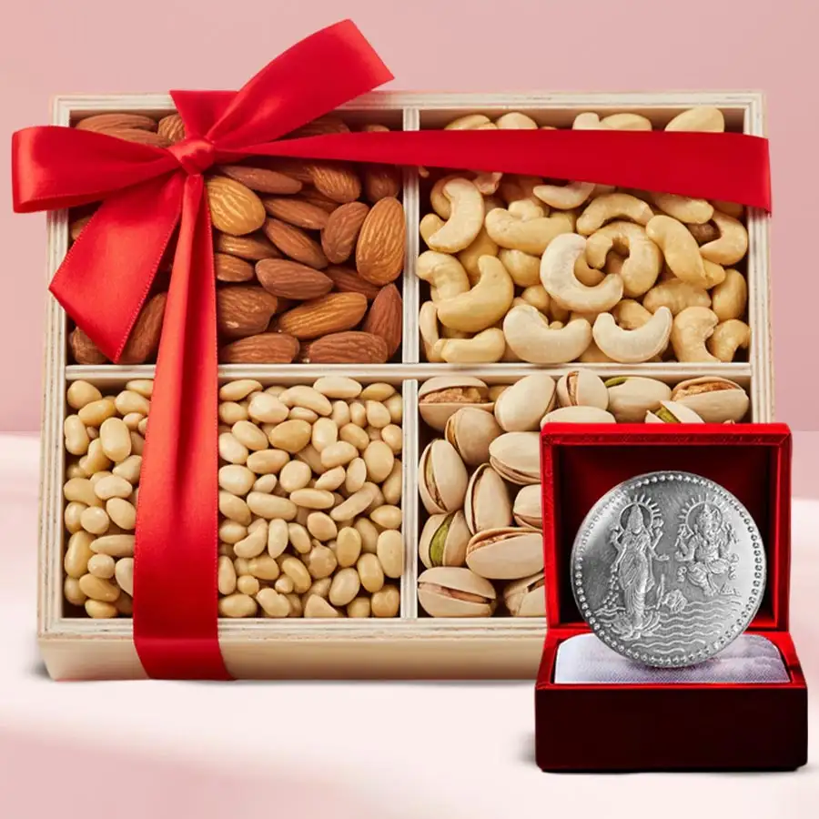 Festive wooden tray filled with assorted premium salted dry fruits and a silver-plated Ganesh Lakshmi coin for Diwali.
