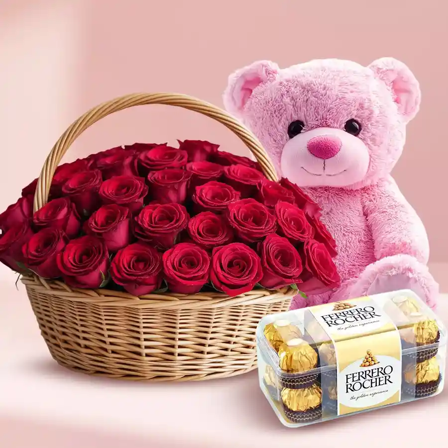 Enchanting basket with 50 red roses, Ferrero Rocher chocolates, and a cute pink teddy bear.