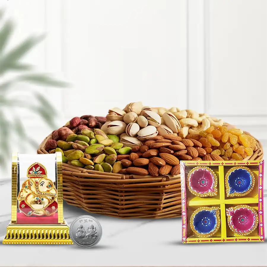 Diwali gift basket featuring premium dry fruits, a Ganesh idol, decorative diyas, and a silver-plated coin.