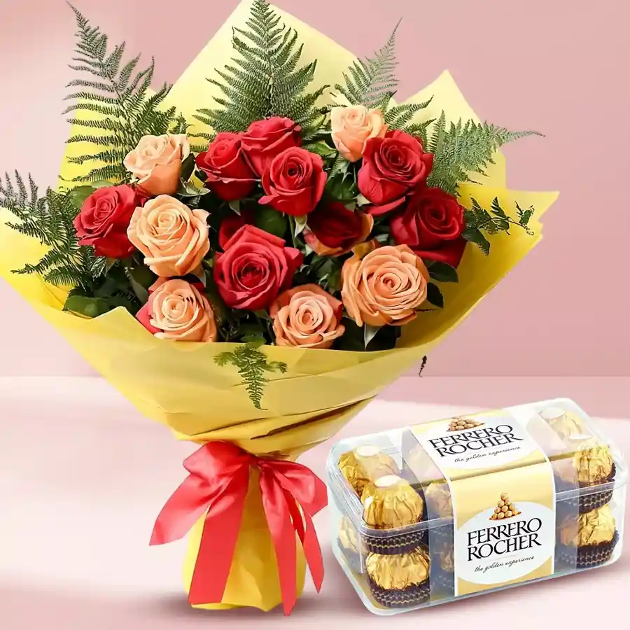 Exuberant red and peach roses bouquet with ferns and Ferrero Rocher chocolates.