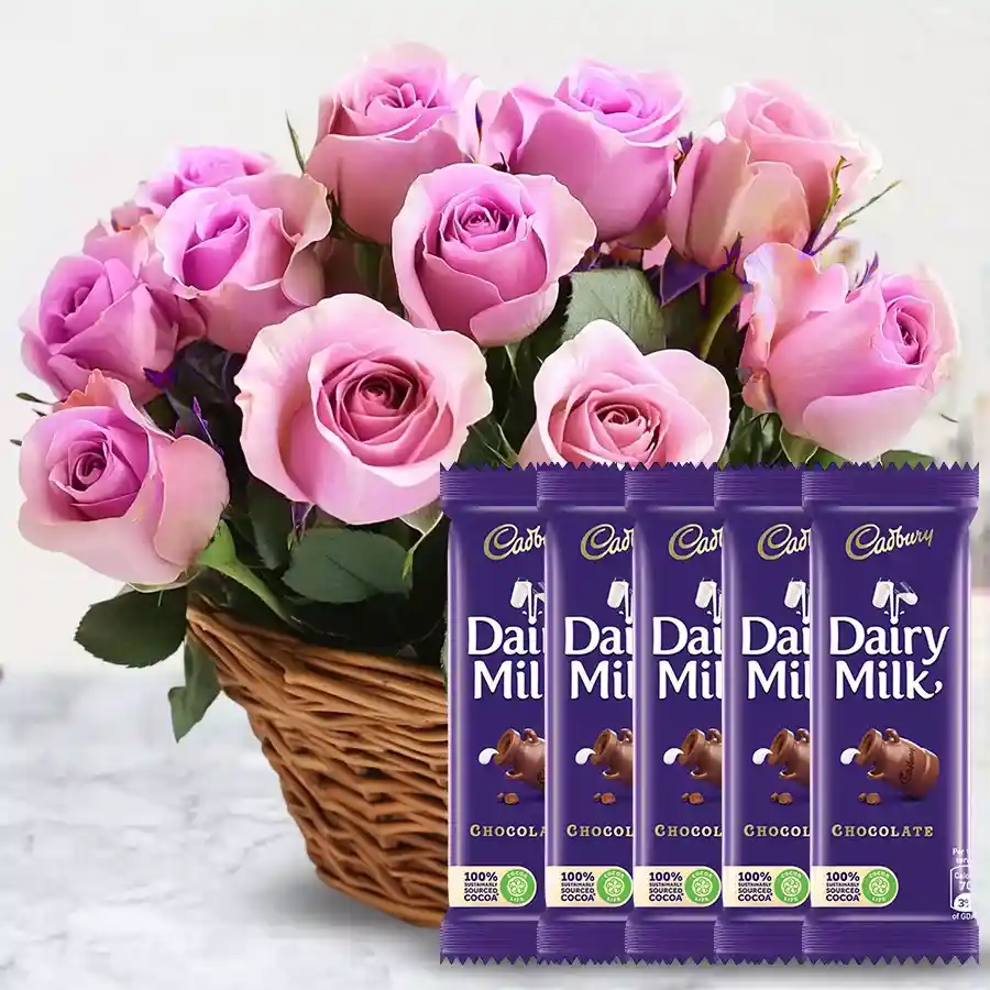 Sweet Serenity combo featuring 12 pink roses in a basket and 5 Cadbury Dairy Milk chocolates.