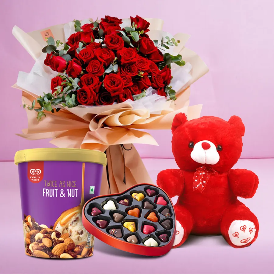 Joyful gift combo featuring red roses, ice cream, a teddy bear, and handmade chocolates.