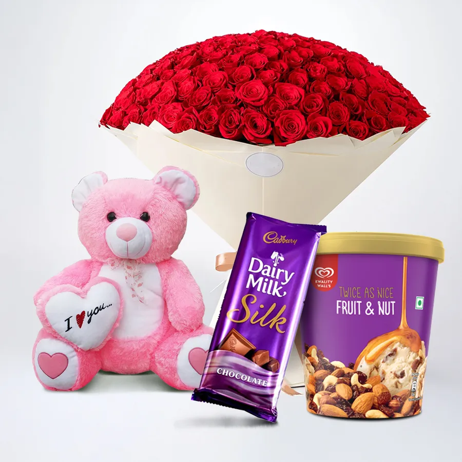 A gift set featuring red roses, ice cream, a teddy bear, and Cadbury chocolate, perfect for expressing love and affection.
