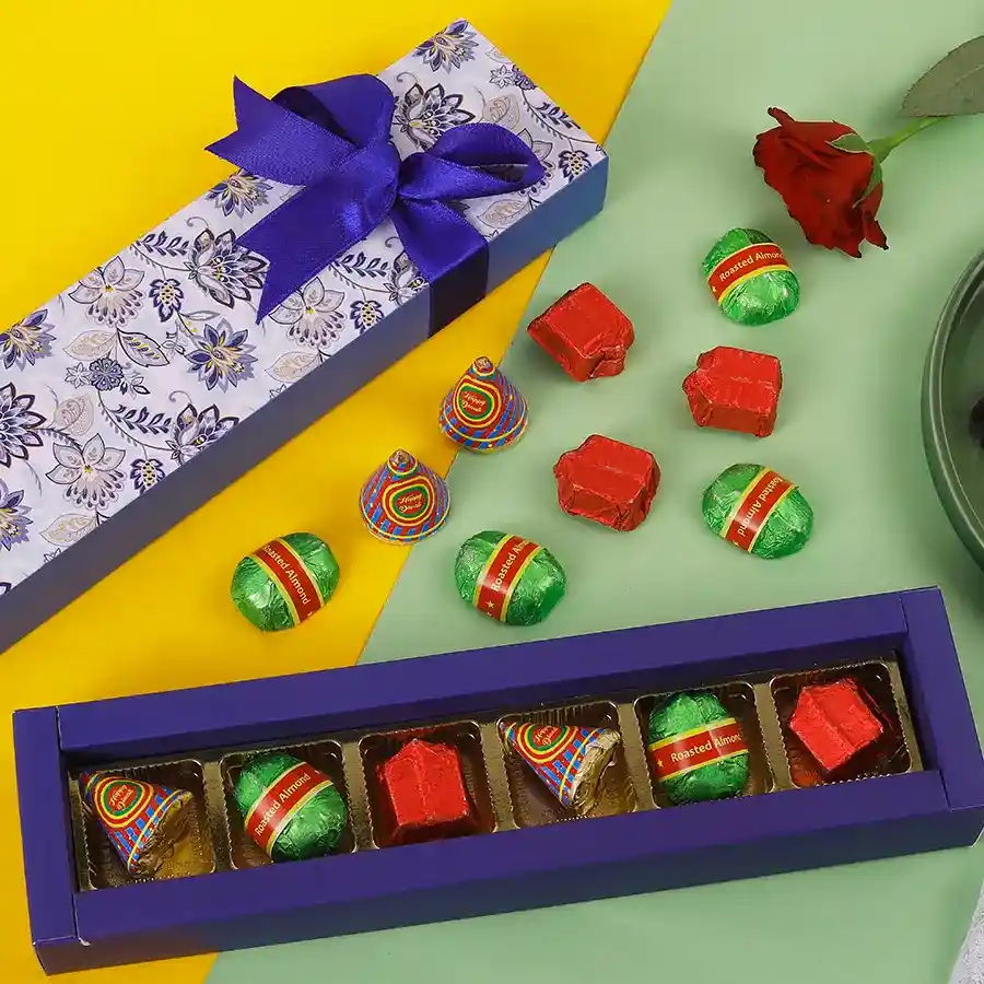 Colorful box of Diwali Delight Chocolate Fireworks containing Roasted Almond Chocolate Bombs, Butterscotch Chocolate Anars, and Milk & Dark Chocolate Lavangis