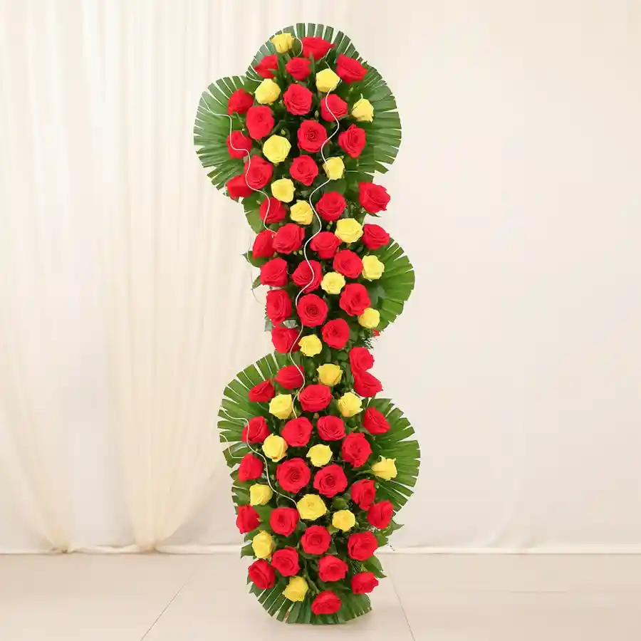 A tall arrangement of 100 super roses paired with a Cadburys Celebration pack, creating a beautiful gift combination for any occasion.