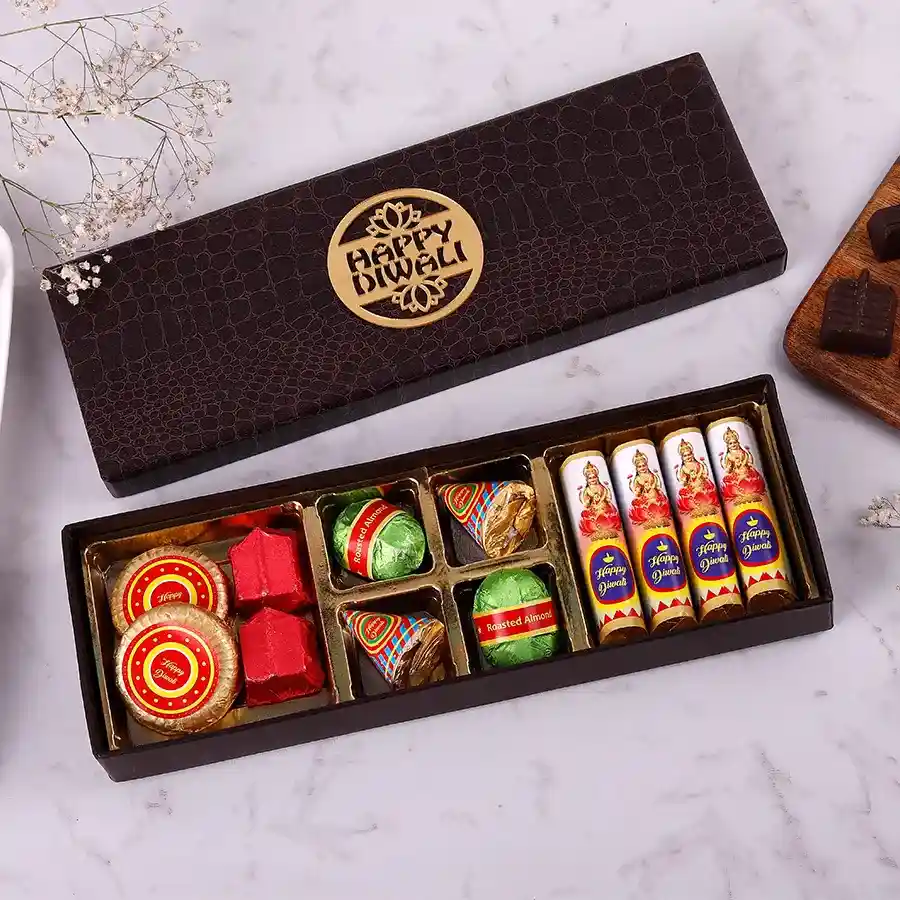Assortment of Diwali-themed chocolates and crisps, including Chakari Almond Florentines, Lavangi chocolates, Chocolate Bombs, Chocolate Anar, and Laxmi Bombs, beautifully packaged for festive celebrations.