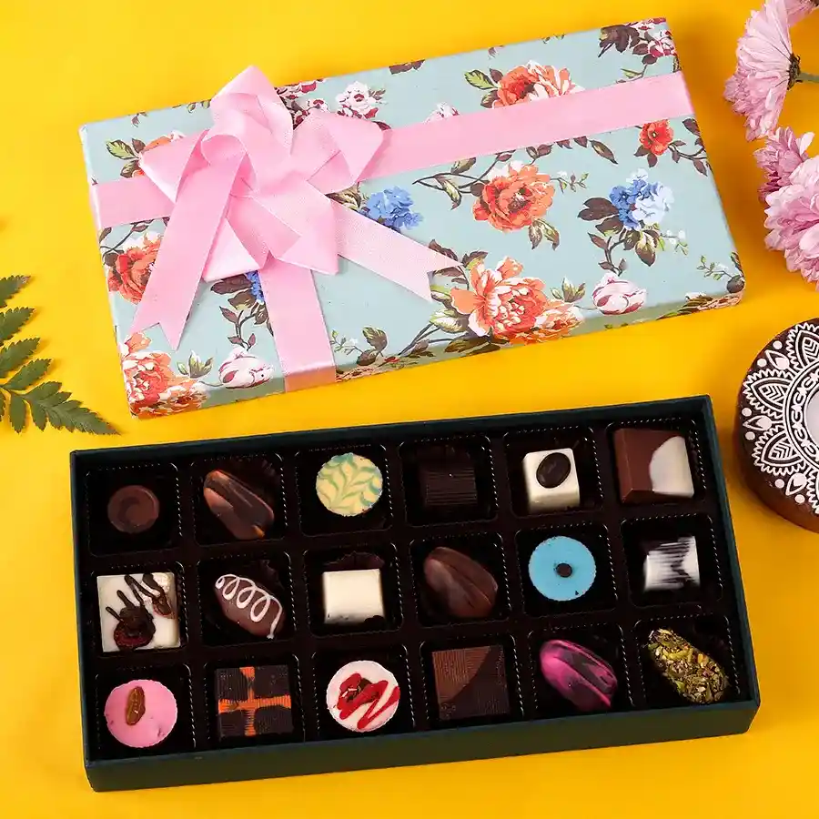 An elegant box of Gourmet Chocolate Medley featuring 18 handcrafted chocolates in various flavors, adorned with stunning floral designs.