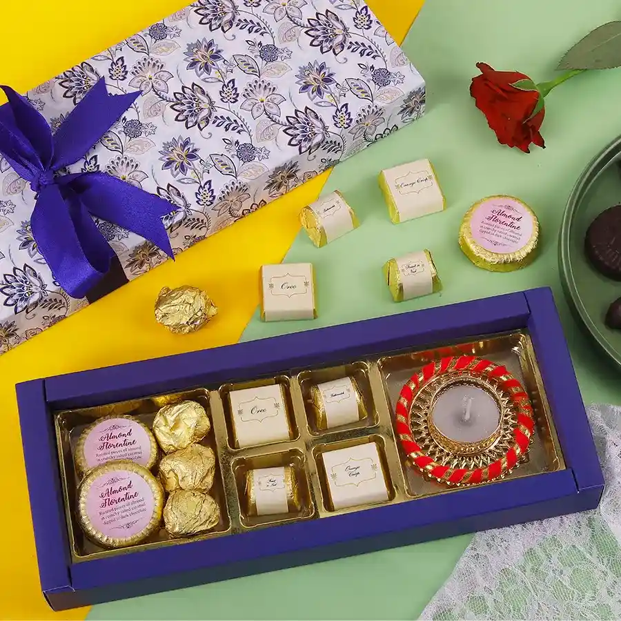 Choco Variety With Diya featuring assorted chocolates, including Almond Chocolate Florentines, Almond Chocolate Rocks, and a decorative diya.
