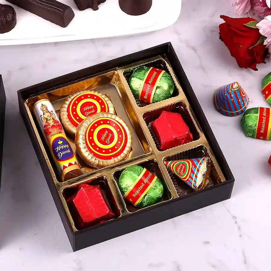 Assortment of luxurious chocolates including granola logs, almond florentine, roasted almond bombs, dark and milk chocolates, and butterscotch treats, arranged beautifully for Diwali celebrations.