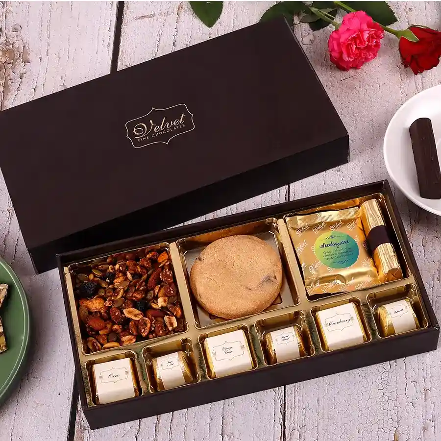 Festive Delightful Diwali Treats box with Sweet & Spicy Trail Mix, Chocochips Cookie, Crunchy Seeds Square, Healthy Granola Log, and assorted chocolates.