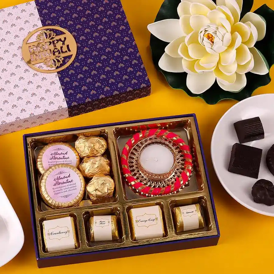 Assorted almond chocolates box with a diya for Diwali celebrations