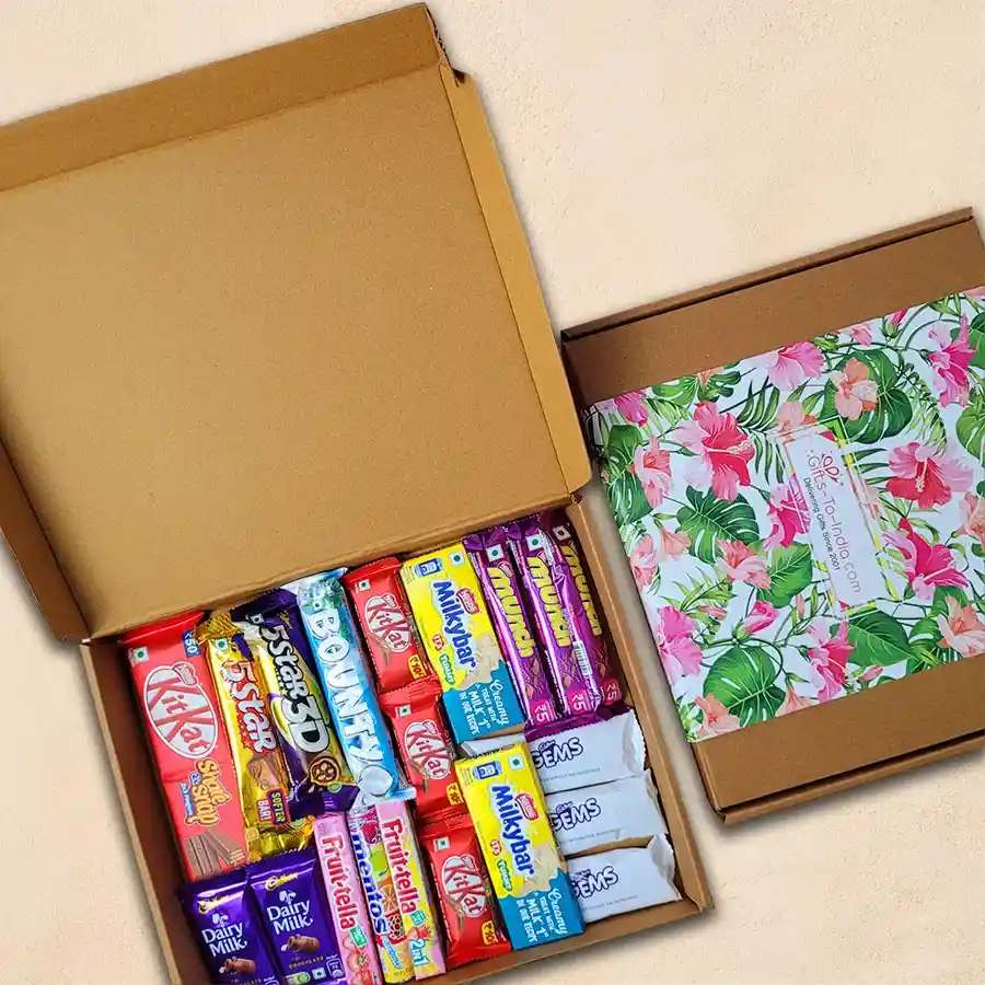 Chocolaty Indulgence Gift Box filled with assorted chocolates and candies including KitKat, Cadbury 5 Star, Bounty, Munch, Milky Bar, Fruitella, Mentos, Dairy Milk, and Cadbury Gems.