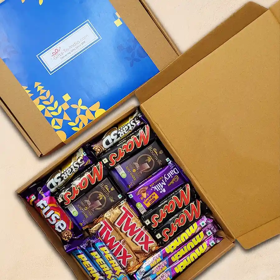 Ultimate Choco Extravaganza Gift Box filled with assorted chocolates including Cadbury Dairy Milk, Mars bars, and Twix.