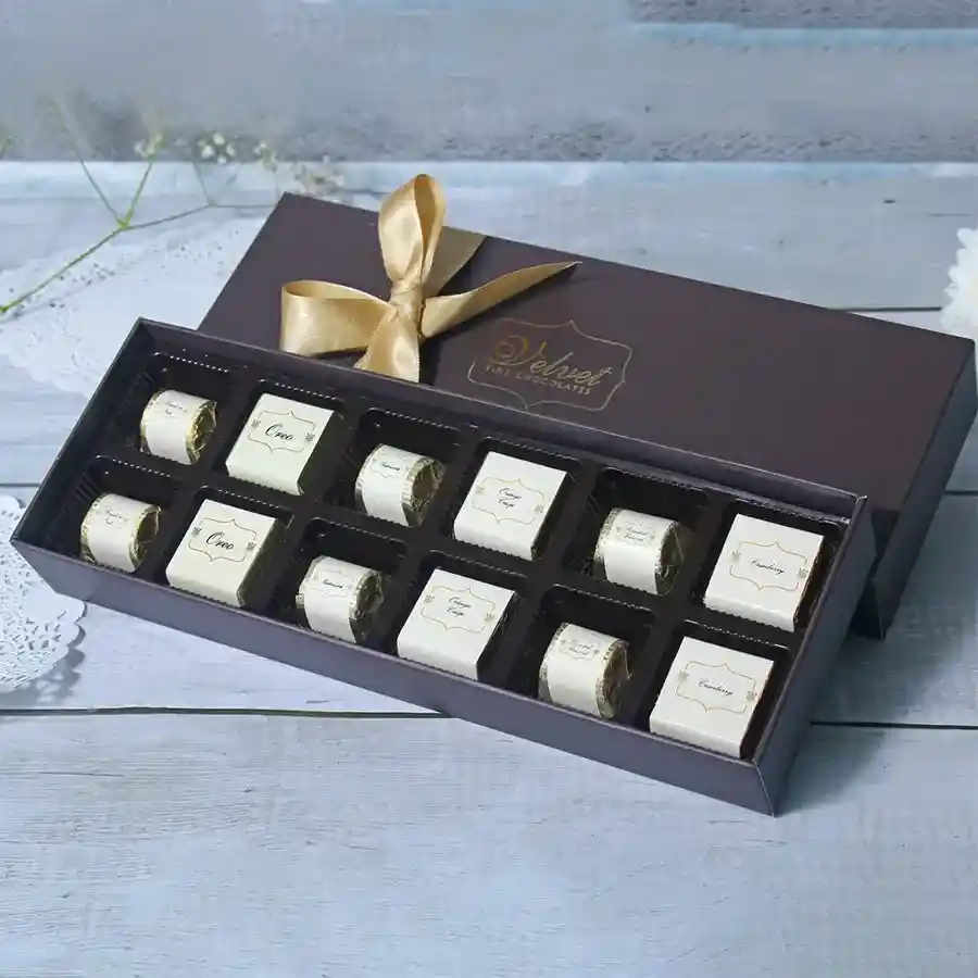 Delectable Chocolates Assortment Box featuring 12 chocolates in 6 flavors: Oreo, Roasted Almond, Cranberry, Orange Crisp, and Fruit & Nut, arranged in a beautifully designed box.