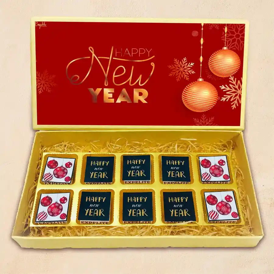A beautifully decorated box of chocolates featuring New Year-themed designs, showcasing an assortment of 10 unique chocolate flavors including roasted dry fruit, tangy cranberry, aromatic paan, rich butterscotch, mixed fruits, and chocochip.
