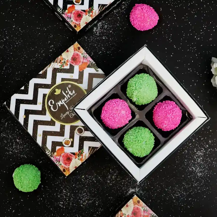 Colorful chocolate truffles with creamy coconut filling arranged in an elegant presentation