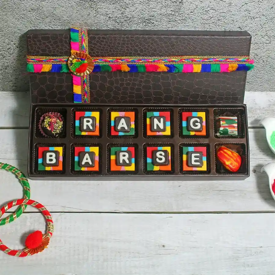 Assorted festive chocolate box with 12 handcrafted chocolates in dark and milk varieties, elegantly presented for gifting.