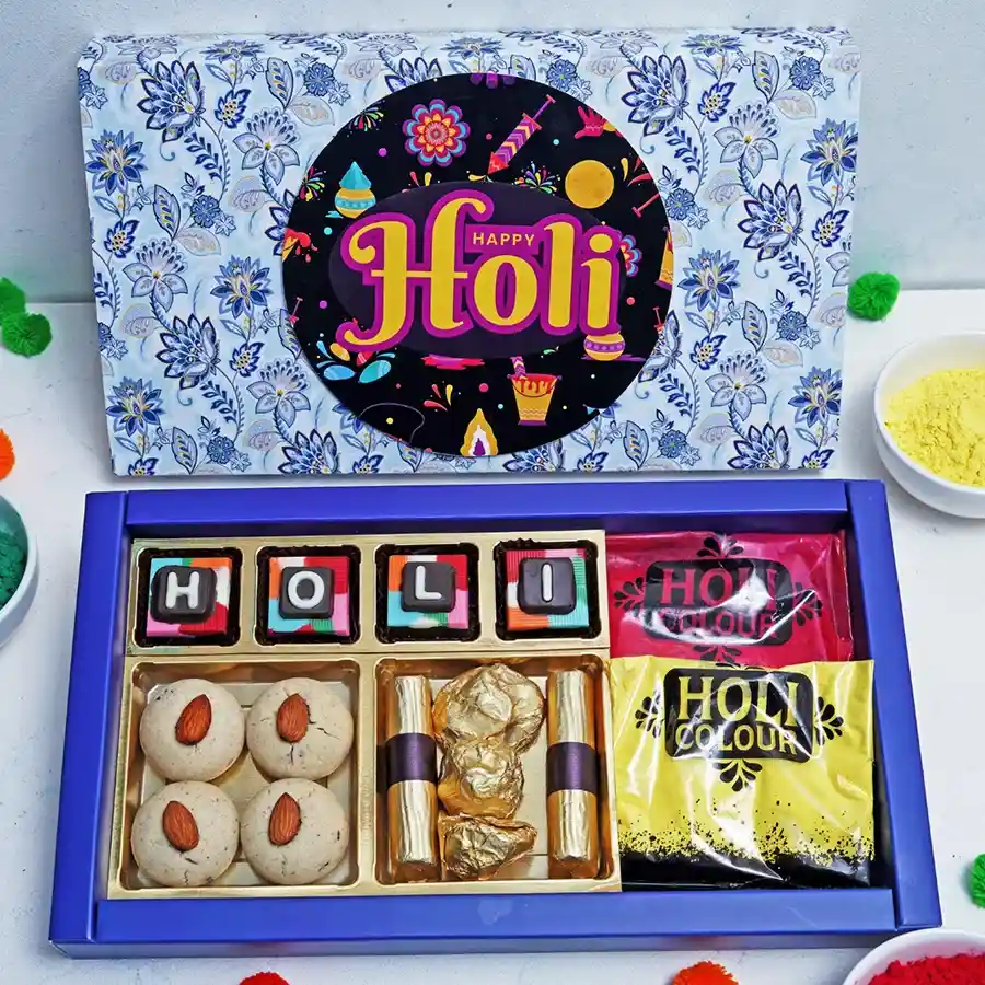Chocolaty Confections Box featuring assorted chocolates, nankhatai cookies, almond rocks, strawberry crisp logs, and Holi colors