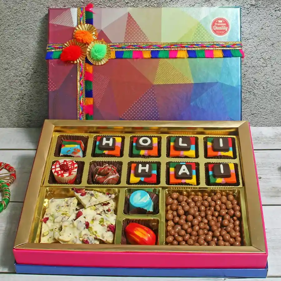 Assorted chocolates in a decorative box with a Coated Butterscotch Chocolate and a Thandai Bar, showcasing a variety of flavors and textures.