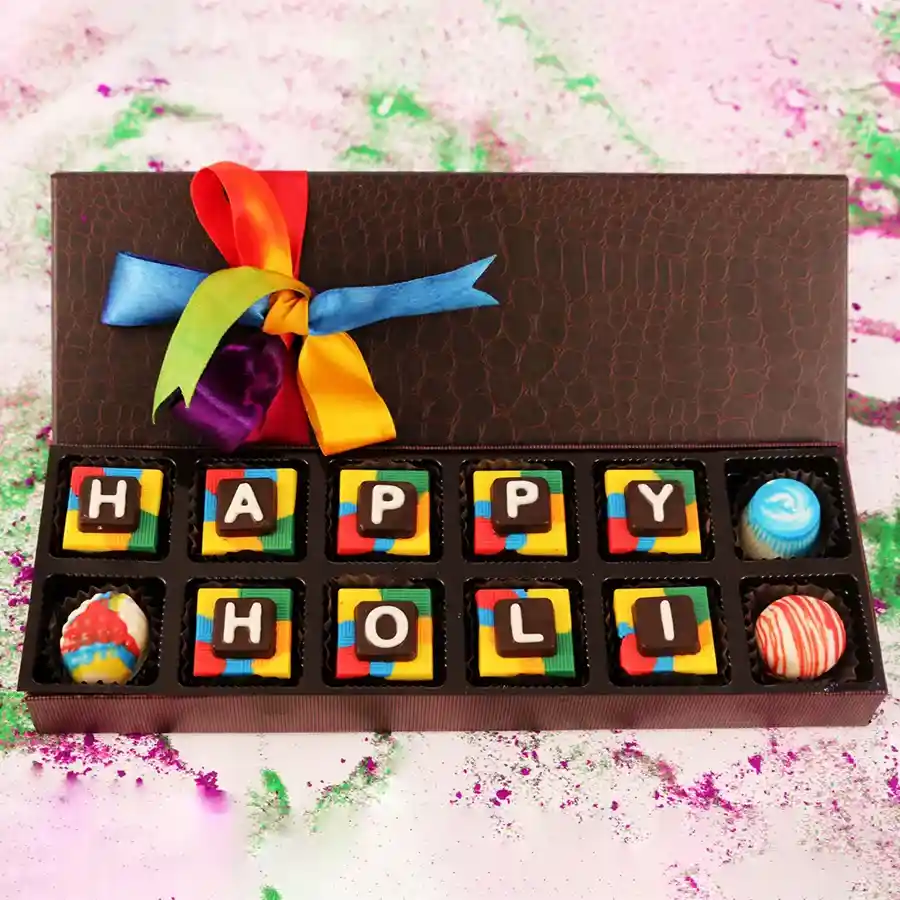 Choco Holi Wishes Box featuring 9 square chocolates with festive designs and flavors including Oreo Chocolate, Cranberry Truffles, and Blueberry Chocolate.