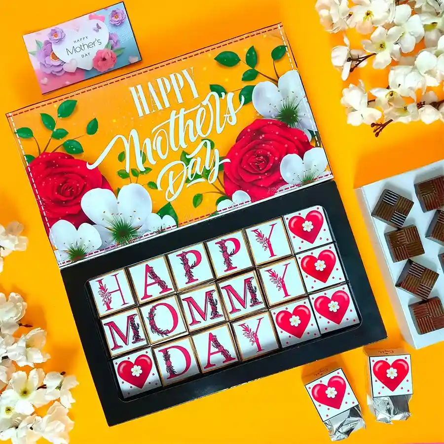 A beautifully arranged box of assorted Mother's Day chocolates, featuring 18 distinct flavors with elegant decorations, alongside a greeting card.