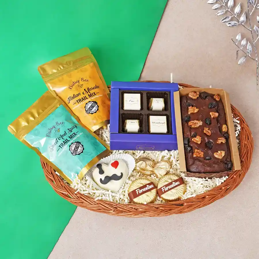 Father's Day gift hamper filled with trail mix, chocolates, tea cake, chocolate rocks, almond florentines, and a hot chocolate piñata.